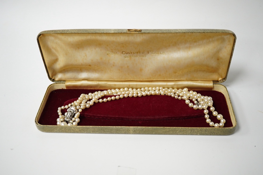 A double strand graduated culture pearl necklace, with marcasite set sterling clasp, 46cm and one other single strand cultured pearl necklace. Condition - fair